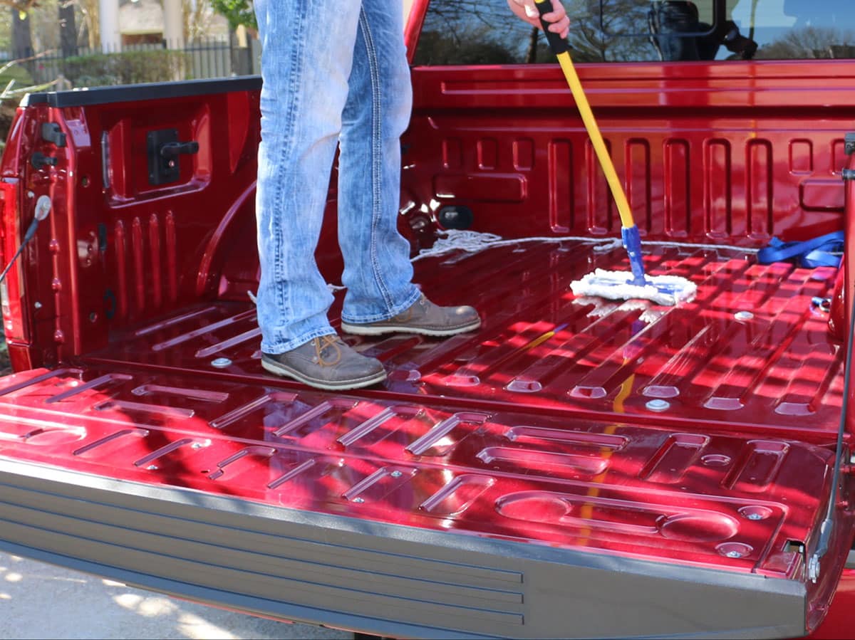 Man cleaning truck with The Simple Scrub Original.