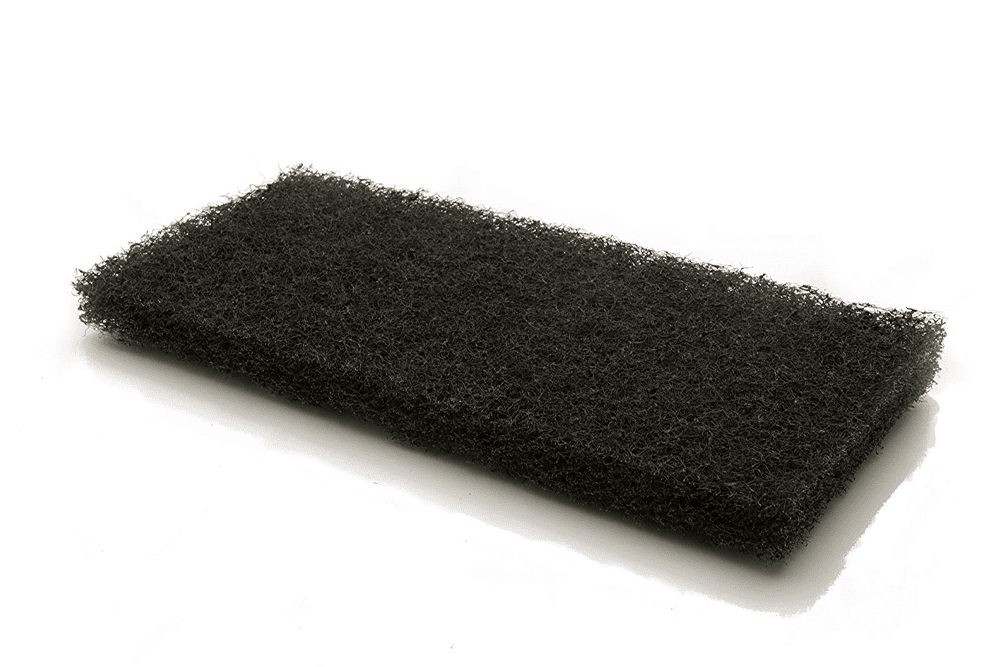 A black cleaning pad by The Simple Scrub