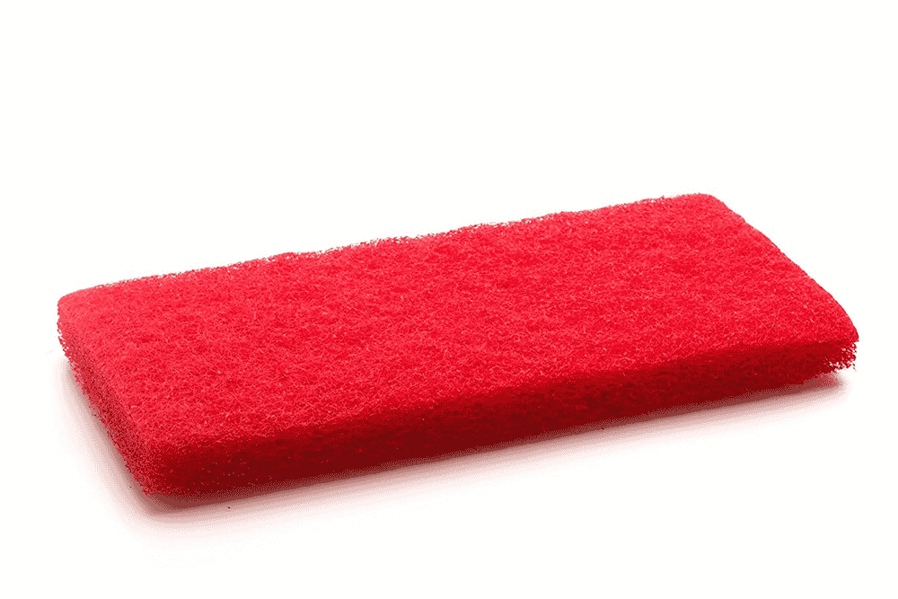 A red cleaning pad by The Simple Scrub