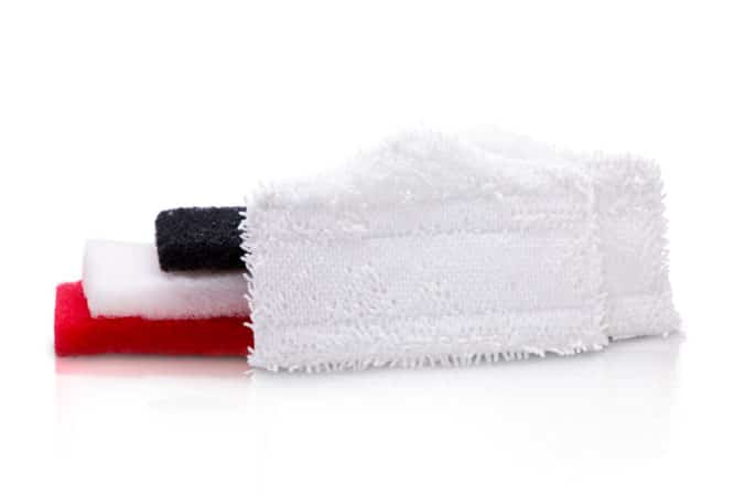 The Simple Scrub Cleaning Combo Package includes two microfiber, one black, one white, and one red cleaning pads