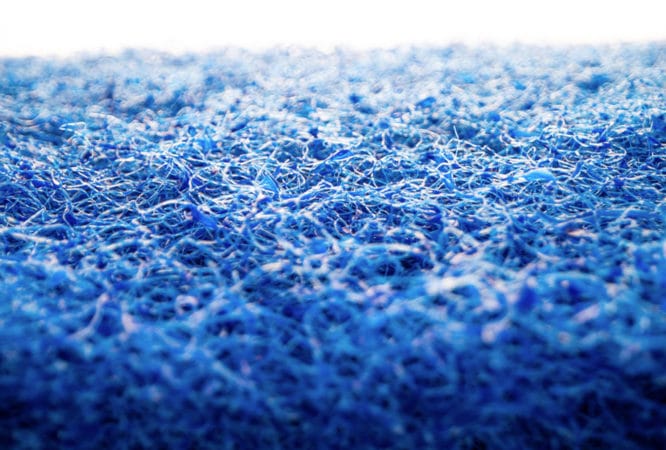 A close up view of The Simple Scrub Blue Pad, one of the coarsest scrubbing pads offered by The Simple Scrub brand.