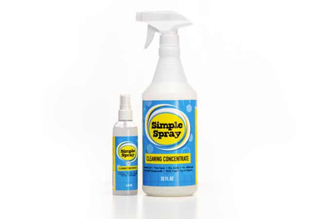 The 32 fluid oz and 4 fluid oz bottles of the Simple Spray cleaning concentrate by The Simple Scrub.